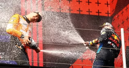 IMOLA, ITALY - MAY 19: Race winner Max Verstappen of the Netherlands and Oracle Red Bull Racing and Second placed Lando Norris of Great Britain and McLaren celebrate on the podium during the F1 Grand Prix of Emilia-Romagna at Autodromo Enzo e Dino Ferrari Circuit on May 19, 2024 in Imola, Italy. (Photo by Mark Thompson/Getty Images)